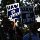 Image: Members of the United Auto Workers (UAW) Local 230 and their supporters walk the picket line