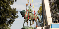 Workers remove the statue of Confederate General Robert E. Lee from a park in Charlottesville, Va.,  on July 10, 2021.